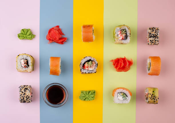 istock Sushi rolls on trendy color background 1305952255