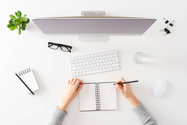 istock Overhead shot of woman using computer 1305952360