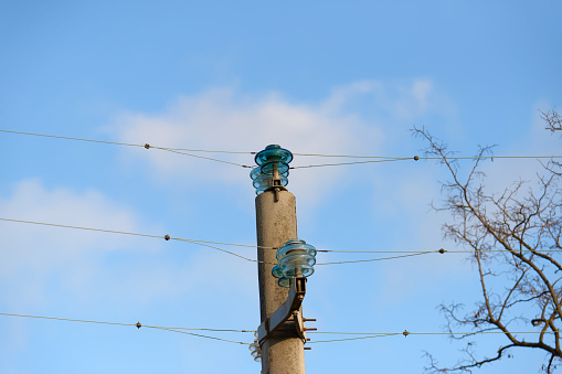 power line and insulator against a blue sky