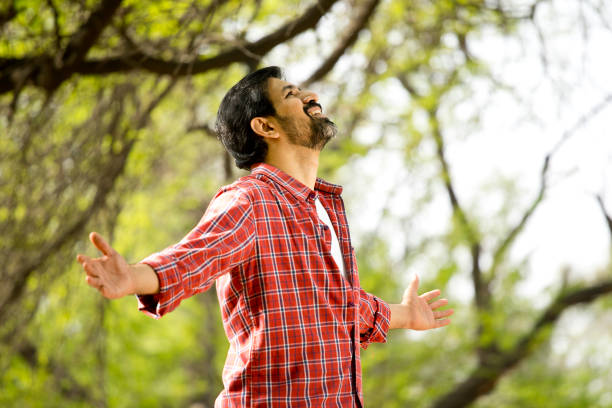 istock man with his arms outstretched at park 1305953514