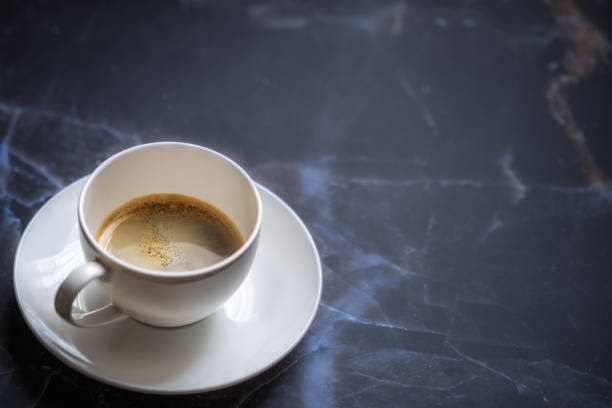 istock Cup of coffee on the marble table 1305954239