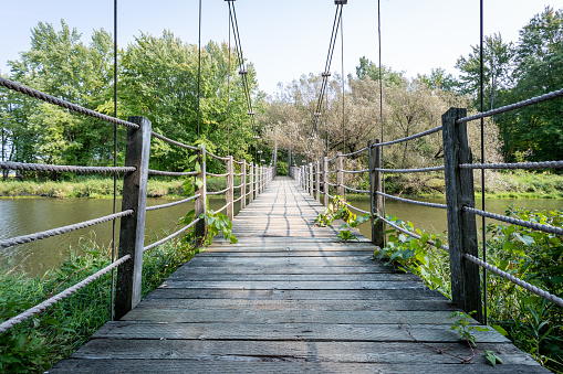 Wooden Suspension Bridge over Lake at Parc national de Plaisance, Quebec, Canada.