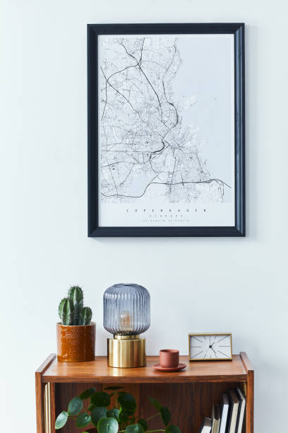 istock Stylish scandinavian living room interior with retro commode, black mock up poster frame, clock, plant, decoration, book and personal accessoreis in home decor. Template. 1305956216