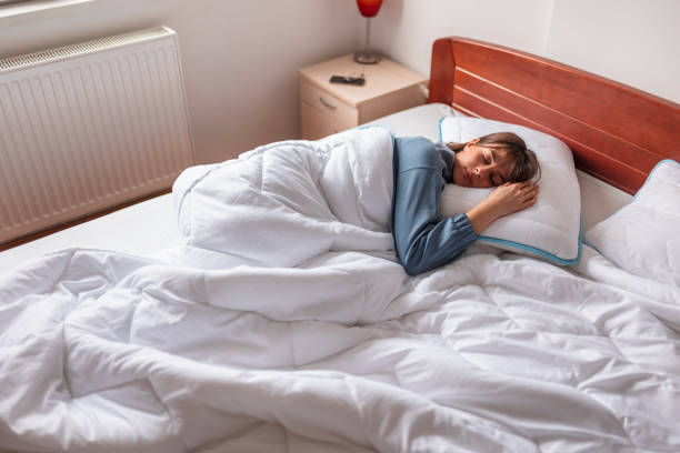 istock Woman sleeping in bed in the morning 1305957837