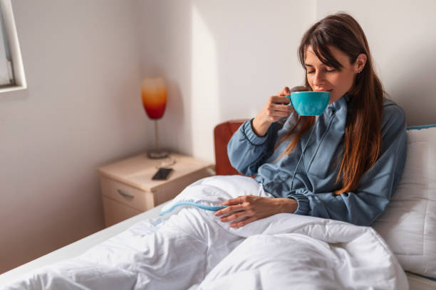 istock Woman drinking coffee in bed 1305958056