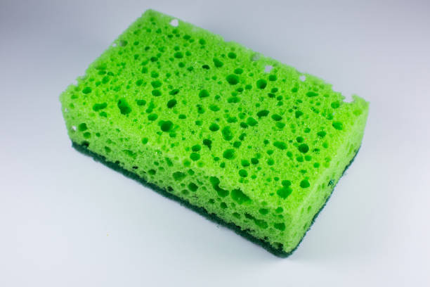 istock Green sponge for washing dishes on white background. Artificial fiber not eco-friendly tool. Things for kitchen. 1305959287