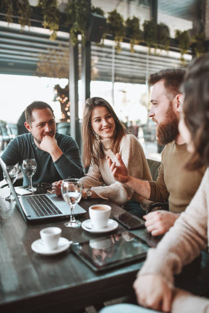 istock Smiling Friends Analyzing Online Market During Coffee Time On Laptop 1305959324