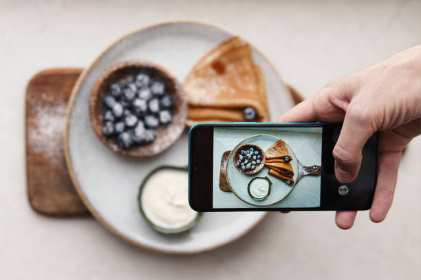 Hands taking photo on smartphone. Hands taking photo of pancakes with smartphone crêpe pancake photos stock pictures, royalty-free photos & images