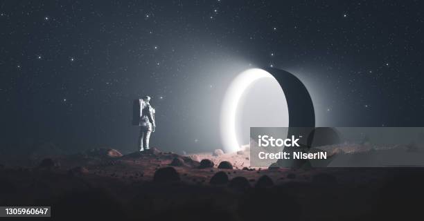 Astronaut On Foreign Planet In Front Of Spacetime Portal Light Stock Photo - Download Image Now