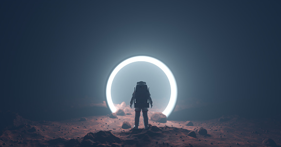 Astronauta en planeta extranjero frente a la luz del portal espacio-tiempo photo