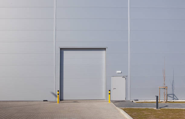 istock Closed white roller shutter door - automatic metal roller door used in factory, storage, garage. 1305960942
