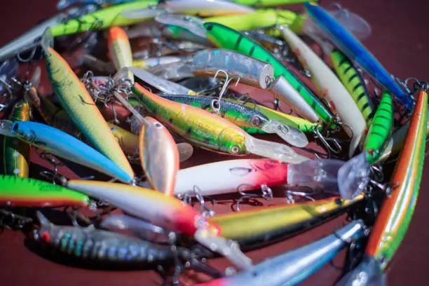 Photo of Fishing lures and tackle in the form of bright fish. Sets of accessories for fishing.