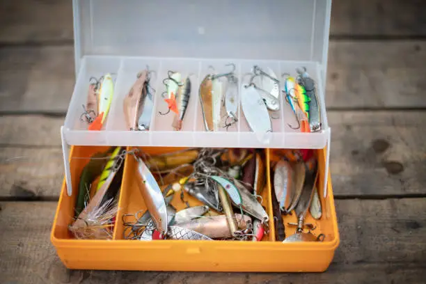 Photo of Fishing lures and tackle in the form of bright fish. Sets of accessories for fishing.