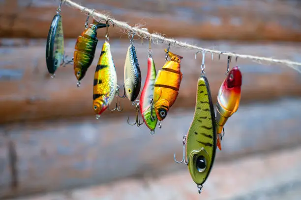 Photo of Fishing lures and tackle in the form of bright fish. Sets of accessories for fishing.