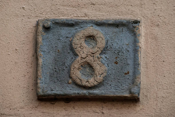 istock Old retro weathered cast iron plate with number 8 closeup 1305963845