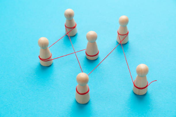 istock Communication between people. The figures are tied with a red thread. spreading rumors 1305965026