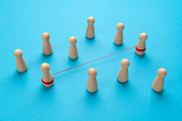 istock Strong bond between two people. A pair of figures are tied with a red thread on a blue background 1305965035