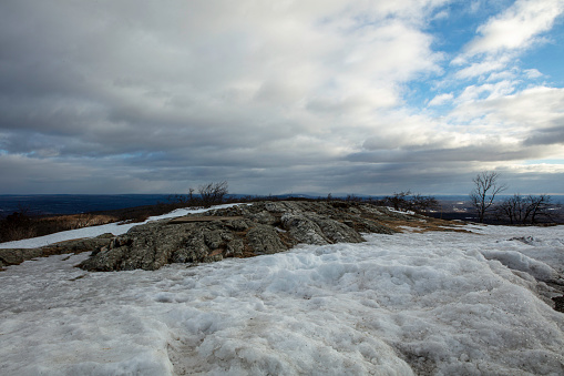 Landscape of snow and rocks and a cloudy sky