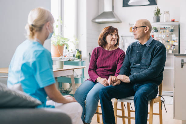 istock Female nurse visiting seniors at home 1305968260