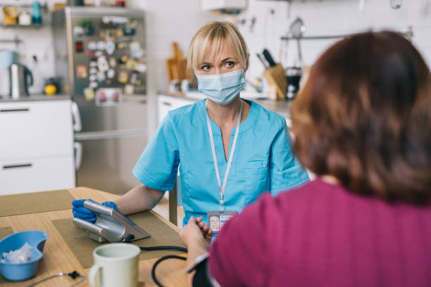 istock Nurse measuring senior patient blood pressure 1305968271
