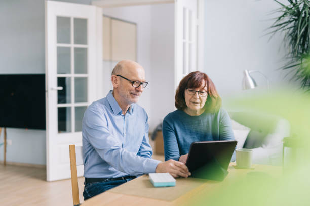 istock Senior couple on video call with doctor 1305968325