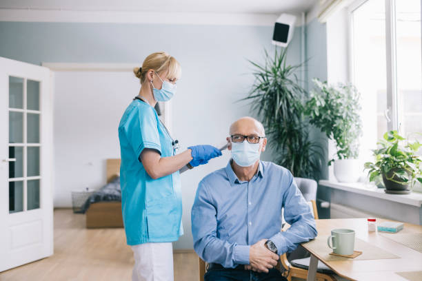 istock Nurse checking patient body temperature 1305968346