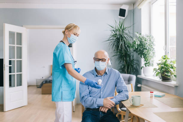 istock Nurse showing  body temperature to his patient 1305968351