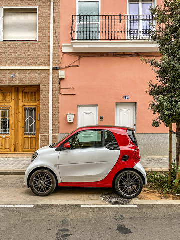 Valencia, Spain - September 7, 2020: Compact car Mercedes-Benz model Smart parked in front of house. There are a lot of cars like this moving around the city