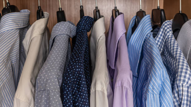 istock Shirts hanging in a closet. 1305969485