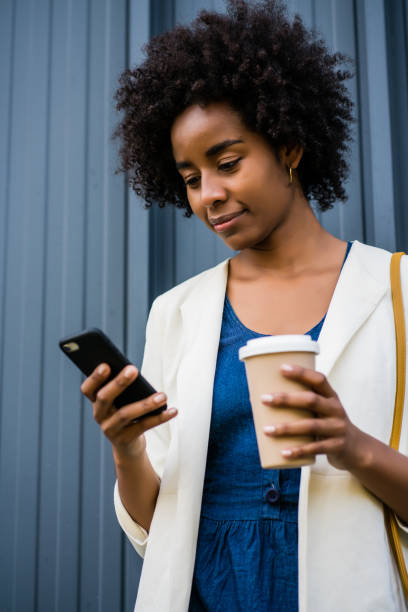 istock Business woman using her mobile phone outdoors. 1305969580