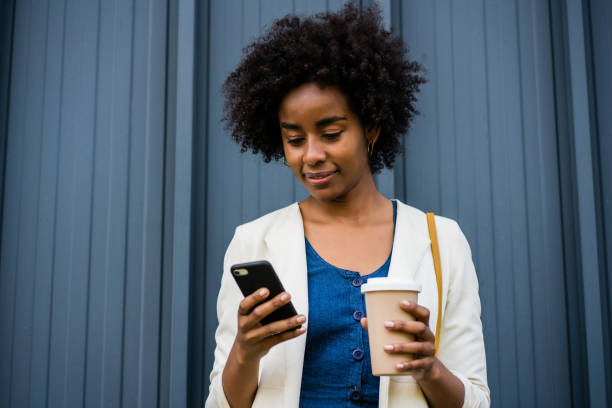 istock Business woman using her mobile phone outdoors. 1305969585