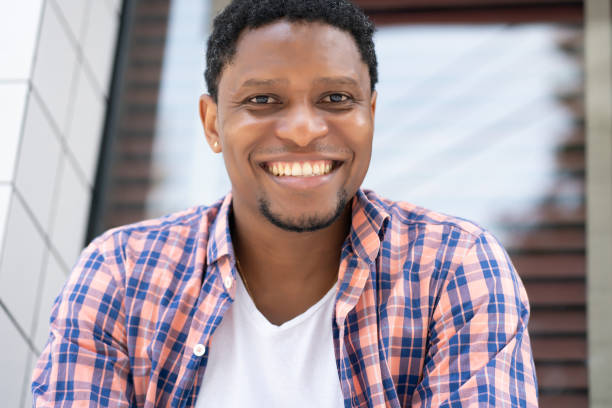 istock African american man sitting at a store window. 1305971301