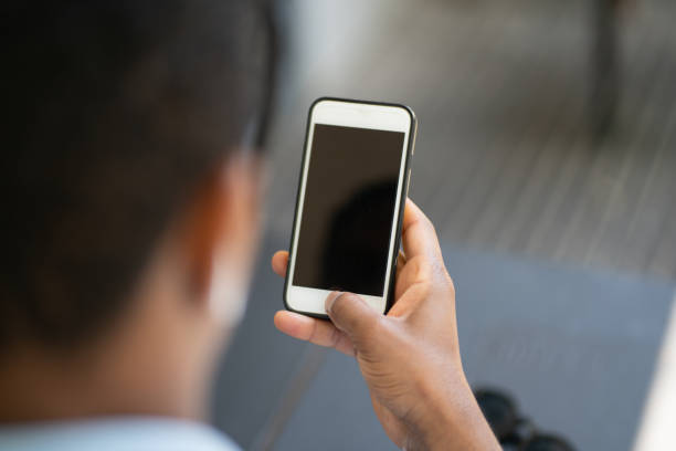 istock Man holding mobile phone with black screen. 1305971311
