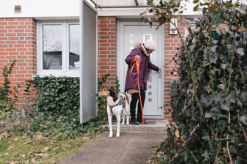 dog walk: woman lock the front door