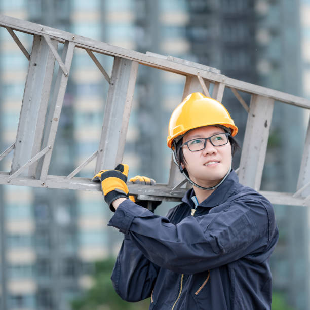 istock Maintenance worker man carrying aluminium ladder 1305971753