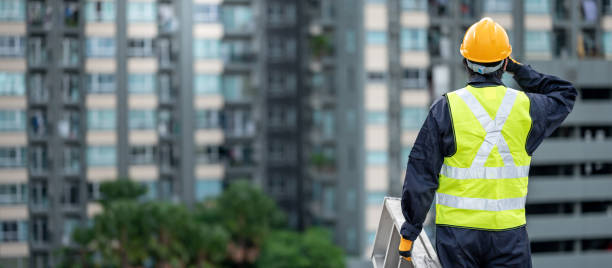 istock Maintenance worker man carrying aluminium ladder 1305971762