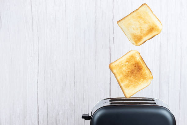 istock bread toaster jumping on wooden background 1305971945