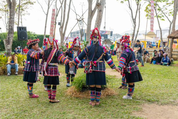 Chiangrai, Thailand - February 16, 2019: Beautiful hill tribe girls in black and red  traditional costume dancing to show to tourits in Singha International Balloon festival 2019 in Chiangrai, Thailand