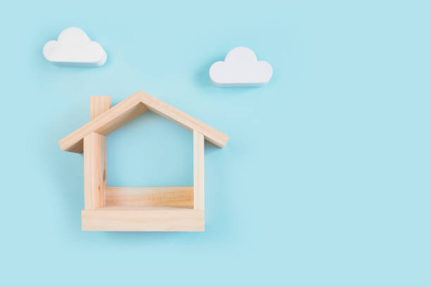 istock wooden house model and mock up with white could on color backgound, Top view 1305975246