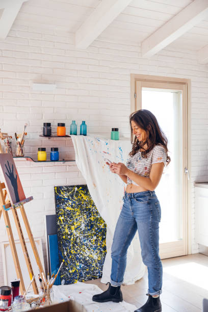 istock Artist talking on the phone in front of her 