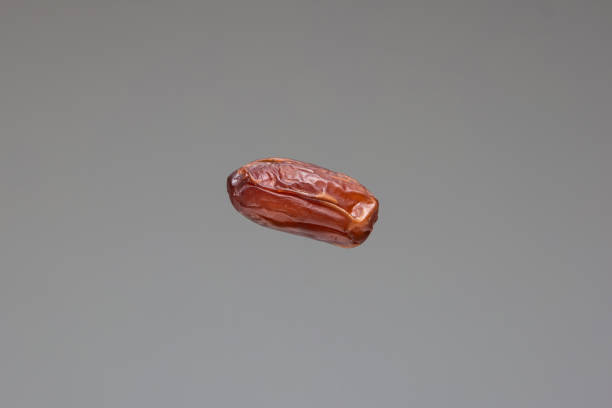 istock Dried ripe date fruit close up studio shot isolated on gray background 1305975837