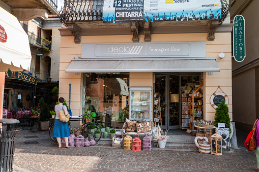 Gift Shop in Menaggio, Italy, with an adult woman tourist browsing outside