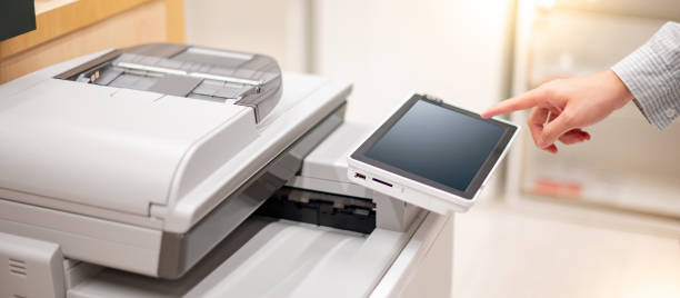 istock Male hand pushing button on photocopier 1305981636