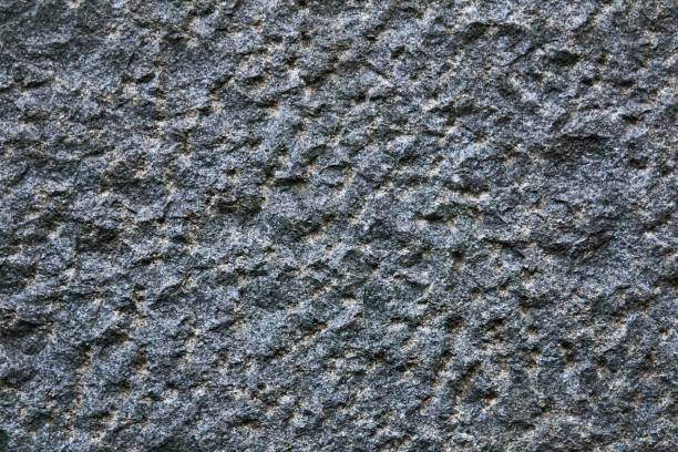 background, texture - the surface of a roughly hewn granite block background, texture - the surface of a deliberately rough hewn granite block roughhewn stock pictures, royalty-free photos & images