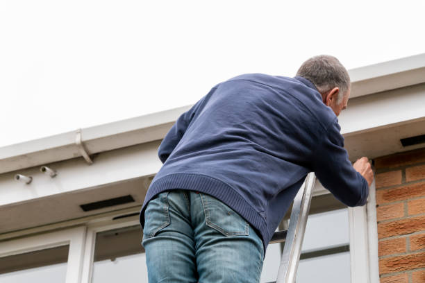 istock Senior man cleaning and putting sealant around leaking windows 1305982794