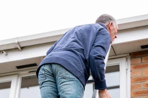istock Senior man cleaning and putting sealant around leaking windows 1305982954