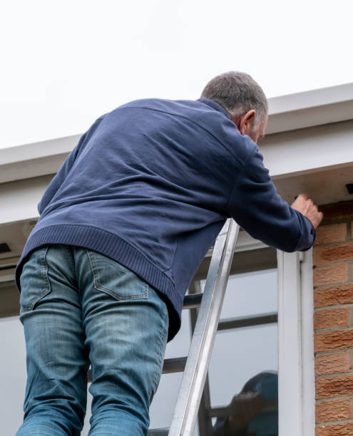 istock Senior man cleaning and putting sealant around leaking windows 1305983017