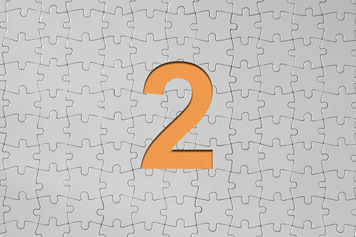 Number two - Jigsaw Puzzle Pieces Forming A Cut Out Orange Number One, Also there is blank areas for your text.