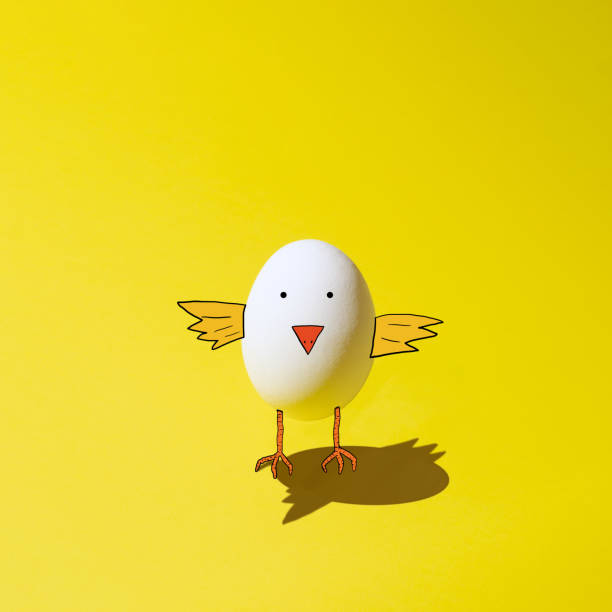 Easter concept yellow background with one white egg. Drawn a hatching chicken.