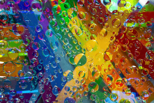 istock Tracery. Variegated multicolored spheres of different diameters are located on a rainbow background. 1305987697